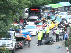 重庆小轿车飞跃隔离带 撞倒对向摩托车